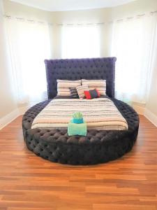 a bed in a bedroom with a blue bed frame at CasaAzul-2605A-Couples Retreat By Pleasure Pier, Beach, Seawall,a block away 5 Minutes from Strands and Cruise Terminal in Galveston