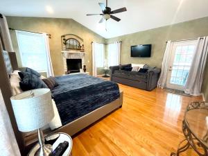 a bedroom with a bed and a couch and a television at Gorgeous Home w Pool & Hot Tub in Schenectady