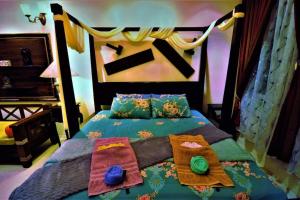 a bedroom with a bed with colorful blankets and pillows at Boutique Studio with exclusive views and amenities in Kuching