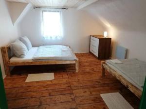 a bedroom with a bed and a dresser and a window at Brána do Českého Švýcarska - ráj cyklostezek in Staré Křečany