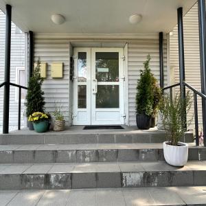 a front door of a house with potted plants at Apartment for one - white in Tallinn