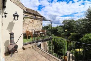 an external balcony with a view of a river at The Little Chantry - Hot Tub, Riverside, Pet Friendly in West Tanfield