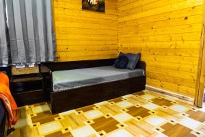 a room with a bed in a wooden room at The Door to Nirvana Cottages in Coonoor