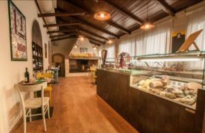 a restaurant with a counter with a lot of food at Vecchia Fattoria in Loreto