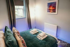 a room with a bed with two pillows on it at Princes st by Prestige Properties SA in Ulverston