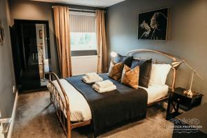 a bedroom with a bed with towels on it at Princes st by Prestige Properties SA in Ulverston