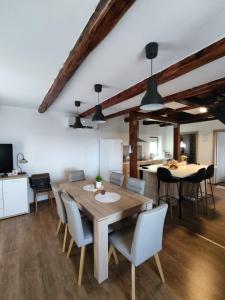 a kitchen and dining room with a wooden table and chairs at Kuća za odmor Obitelj Kušan in Veliki Erjavec