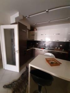 a kitchen with a counter and a stool in a room at Hotel Princ in Shkodër