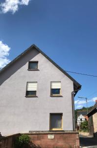 a house with four windows on the side of it at Ferienwohnung Haus Maja in Holzkirchen