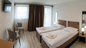 מיטה או מיטות בחדר ב-Penzion Kamence