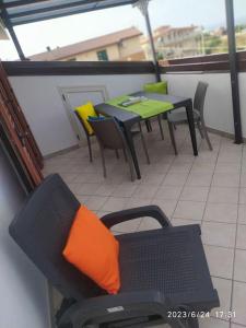 a balcony with tables and chairs on a building at Casa Vacanze Il Roseto in Roseto Capo Spulico +20 photos