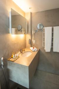 a bathroom with a sink and a mirror at Serena Buzios in Búzios
