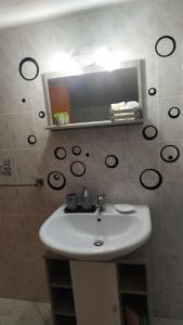 y baño con lavabo y espejo. en Splendido Attico, en Roseto Capo Spulico