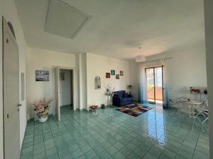 a living room with a blue couch and a table at B&B Orizzonte Blu in Maratea