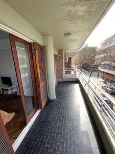 a balcony of a building with a view of a street at Departamento Necochea in Rosario