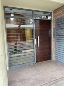 a garage door of a house with a sign on it at Departamento Necochea in Rosario