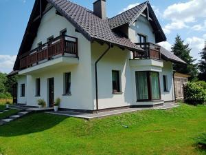 a white house with a black roof at NASZE 4 KĄTY in Junoszyno