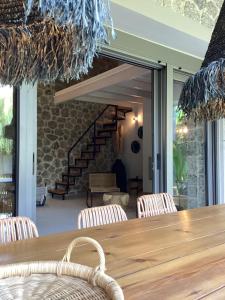a dining room with a wooden table and chairs at Villa Tartaya in Dassia