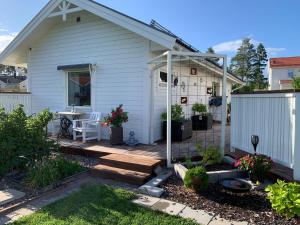 a house with a wooden deck and a patio at Studion in Falun