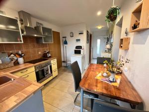 a kitchen with a wooden table in a room at Ferienwohnung Thees in Ummanz