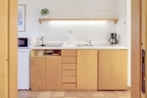 a kitchen with a sink and a counter at Appartamenti San Carlo in Costermano