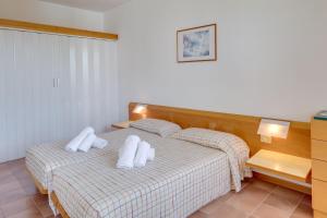 a bedroom with a bed with two white pillows at Appartamenti San Carlo in Costermano