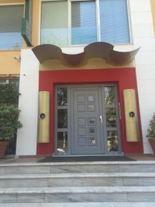 a red and white building with a door at Αρέθουσα easy view in Chalkida