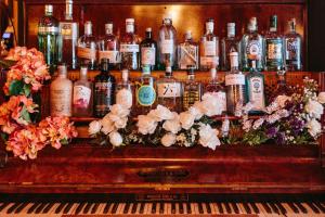 a group of bottles of alcohol sitting on top of a piano at Glasgow Grosvenor Hotel in Glasgow