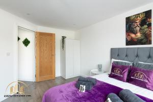 una camera da letto con un grande letto con lenzuola viola di Dionysus Apartment - The Celebration of Town a Southampton