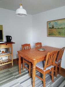 a wooden dining room table with four chairs at La casita linda in Eberbach
