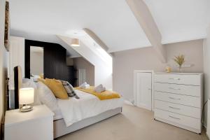 a white bedroom with a bed and a dresser at Terrace View Home in South Shields, Sleeps 7 in South Shields