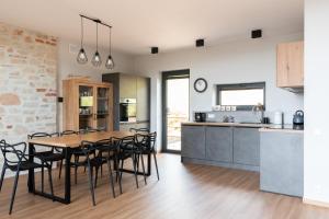 a kitchen and dining room with a table and chairs at Willa Rustica in Muszyna