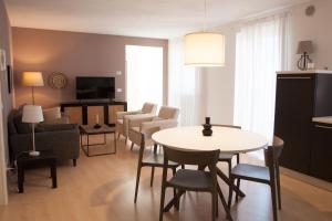 a living room with a table and chairs at Ambiente 90 in Levico Terme