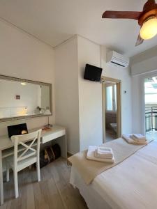 a bedroom with a bed and a desk and a mirror at Hotel Elite in Cervia