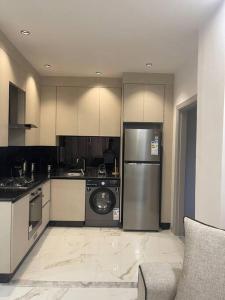 a kitchen with a refrigerator and a dishwasher at Oqdeh Delux Apartments in Jerash