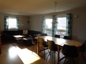 a living room with a table and chairs and a couch at Sisimiut Bed & Breakfast in Sisimiut