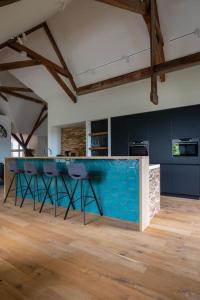 a kitchen with a blue counter in a room at Park Lofts Groningen Penthouse in Groningen