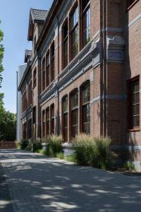 a brick building with a street in front of it at Park Lofts Groningen Penthouse in Groningen +28 photos