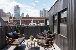 a group of chairs sitting on a balcony at 78-4A 2BR Duplex with a Balcony Prime UES in New York