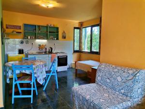 a small kitchen with a table and a couch at Вила Фани Синеморец in Sinemorets