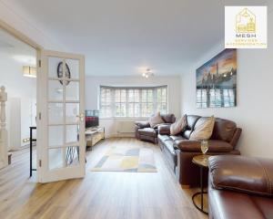 a living room with a couch and a table at Ashford Home with 3 Bedrooms, Ideal for Contractors by Mesh Accommodation in Ashford