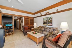 a living room with a couch and a tv at 1st Floor Kiahuna 1br Condo, Garden View, Athletic Club KP422 in Koloa