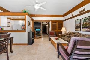 a living room with a couch and a table at 1st Floor Kiahuna 1br Condo, Garden View, Athletic Club KP422 in Koloa