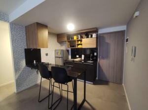 a kitchen with a table and chairs in a room at Departamento en condominio de Equipetrol in Santa Cruz de la Sierra