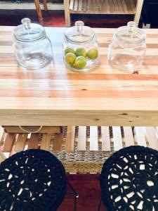 a wooden table with a bowl of limes on it at Loft on Long in Hermanus