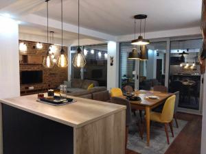 a kitchen and living room with a table and chairs at COSMO Apartman Prilep in Prilep