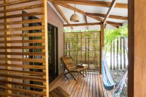 a room with a hammock on a deck at Ohana Villas in Santa Teresa Beach