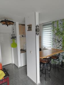 a kitchen with a table and chairs in a room at Apartman Kuč Divcibare in Divčibare