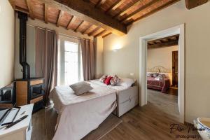 una camera con un grande letto e una camera con un letto di una piazza di La casa delle Rondini a Forcoli