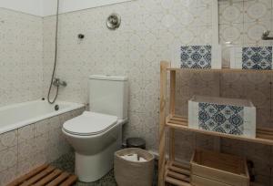 a bathroom with a toilet and a bath tub at Lisbon - Low Cost - Airport - Subway in Lisbon